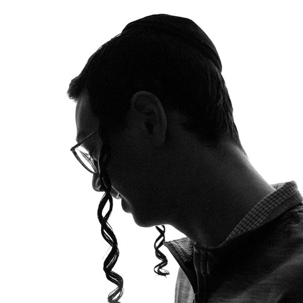 Silhouette of a person meditating against a cyan circular background.